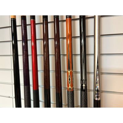 Wide assortment of used billiard cues, snooker, pool cues, racks, triangles and more at various prices